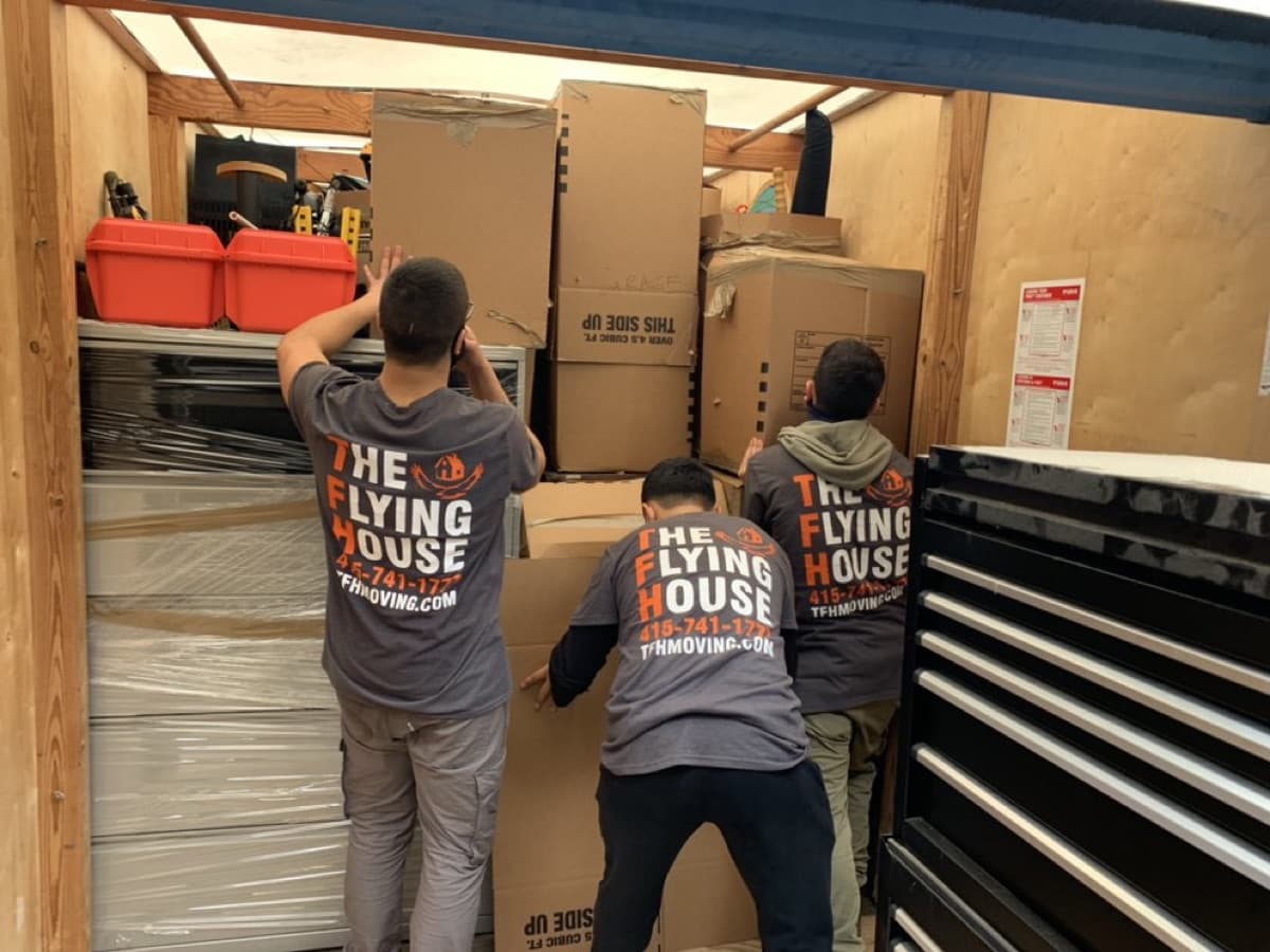 TFH crew loading boxes inside a moving truck
